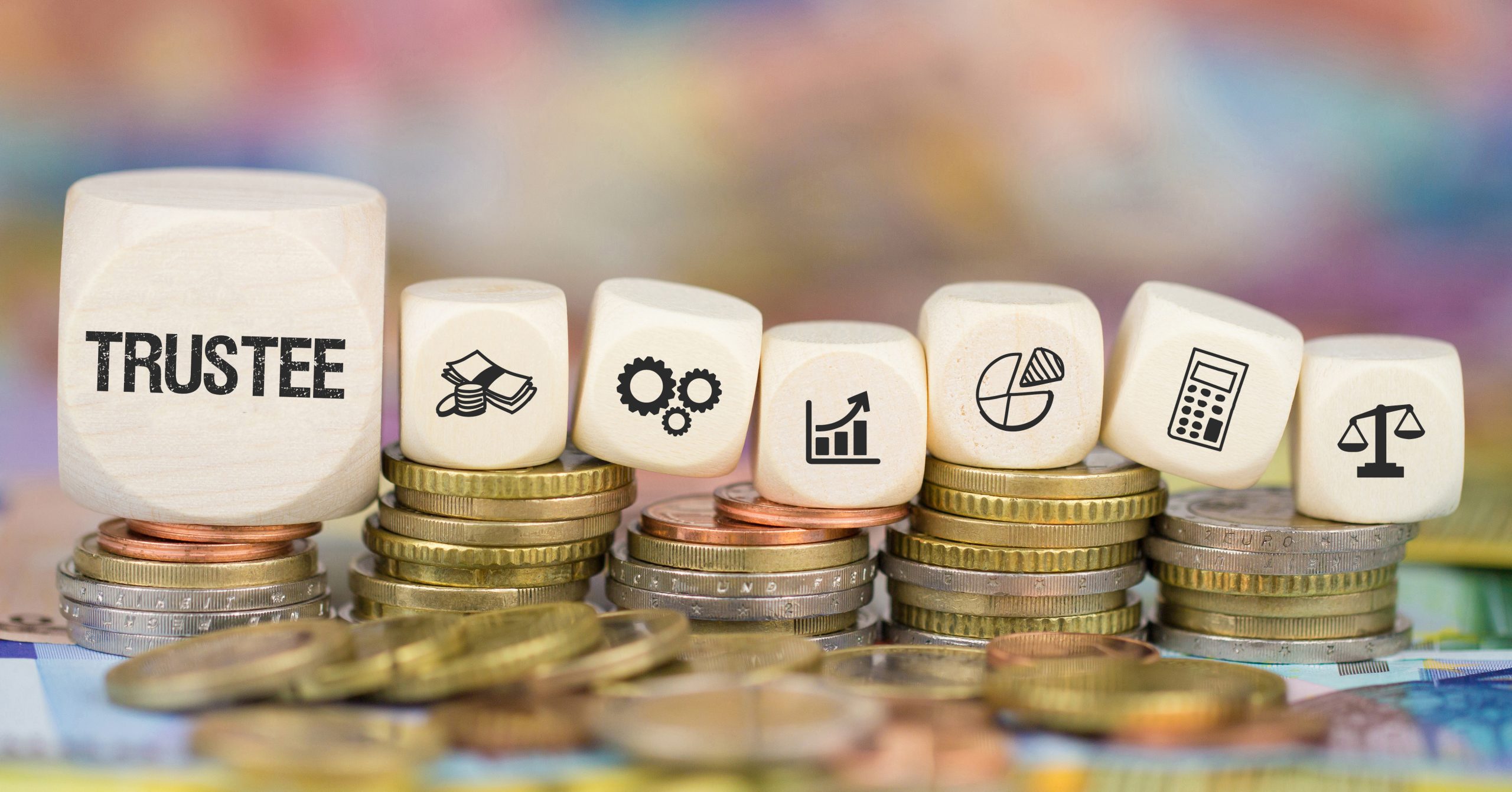 Trustee training image; dice on top of stacks of coins with the word trustee and different icons on the dice.
